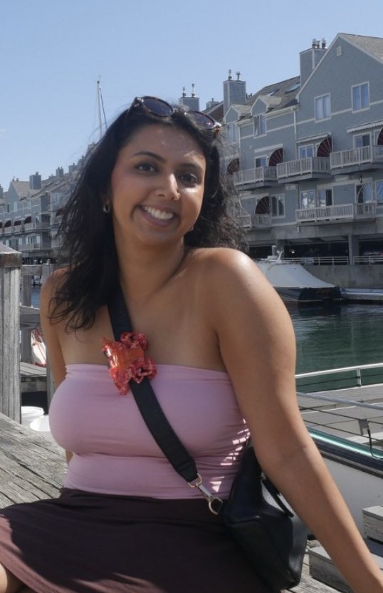 Anmol smiling on a dock